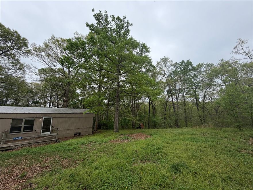 Opportunities like this don’t come around often—especially with this much potential at this price point. Welcome to 15435 Realtree Rd, where you’re getting more than just land… you’re getting a head start. Utilities are already in place, saving you time, money, and hassle from day one.

Tucked away for privacy but still incredibly convenient, this property is just 13 minutes to downtown Centerton and about 22 minutes to Bentonville—giving you that perfect balance of peaceful living without feeling disconnected.

Yes, the mobile home needs work—but that’s where the opportunity shines. Renovate it and live on-site while you build your dream home, bring in a new double-wide, create a custom build, or design the perfect tiny home retreat. The groundwork is already here—just bring your vision.

If you’re looking to build, or create your own homestead, this property checks the boxes in a big way.
Financing will need to be land or construction loan. NO RD / FHA LOANS. Property is being sold as-is, with no repairs.