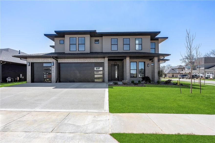 Nestled within the esteemed gated community of Scissortail, this contemporary home exudes sophistication and comfort. Its modern facade hints at the luxury within, where a spacious living room basks in abundant natural light streaming through expansive windows, complemented by a cozy gas fireplace. The kitchen is a culinary haven, boasting two-tone cabinets, quartz countertops, pot filler, extensive accent lighting, veggie prep sink and high-end Cafe appliances including a remarkable six-burner range with griddle and double ovens. Elegant dining room with custom drop-down wood ceiling and dry bar. Luxurious primary suite with wood tray ceiling, a captivating wallpaper accent wall, and a spa-like bathroom featuring double sinks, designer touches, smart mirrors, soaking tub & fully tiled walk-in shower with rain head. Additional highlights include a main-level study and a secondary bedroom. Upstairs bonus room with a wet bar perfect for entertaining. Sprawling outdoor covered patio overlooking the fenced corner lot.