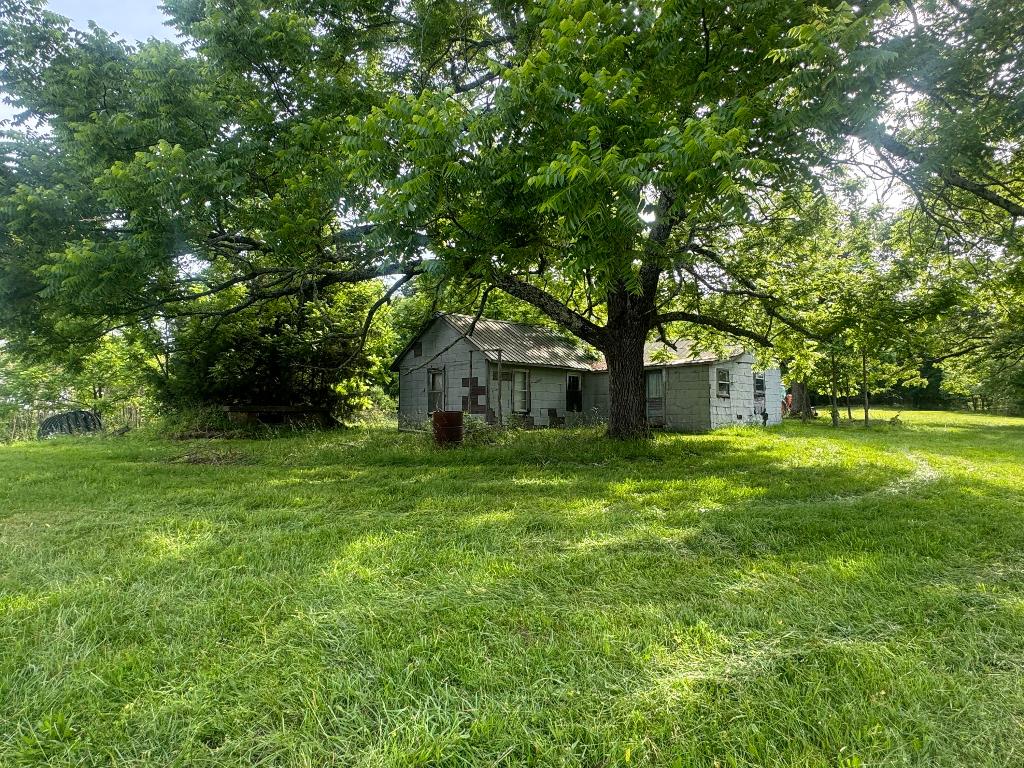 Old homestead located next to the Ozark National Forest. What a nice little tract of land in the Deer Community of Newton County! Comes with an older mobile home and metal garage building. Property has several black walnut trees and distant mountain views. Great hunting in the area, lots of ATV riding and Piney Creek is close.