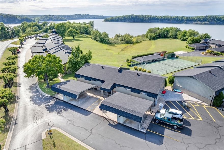 This fully updated, turnkey condo at Heritage Bay off the Hwy 12 bridge is move-in ready and comes completely furnished — just bring your bags! Enjoy breathtaking Beaver Lake views from your private balcony and living area, complemented by thoughtfully curated designer finishes throughout. Conveniently located just minutes from downtown Rogers. Inside, you'll find herringbone LVP flooring, a fully renovated kitchen with updated granite countertops, and a spa-inspired bathroom featuring a stunning tile shower with a glass door, updated granite countertops, refreshed interior paint, trim, and light fixtures throughout. Every detail has been carefully considered, leaving nothing left to update. Outside, enjoy the convenience of your own detached carport along with exceptional community amenities including a sandy beach with lake access, an inground pool, tennis courts, a clubhouse, and a fitness center — all set against the stunning backdrop of Beaver Lake. Property does not come with boat slip.