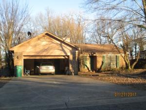 Brick 4 bedroom 2 bath home with fenced yard, large shed, and sun room. Needs a little TLC.