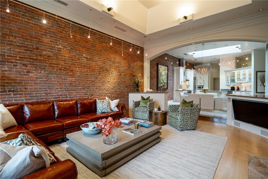 Custom designed condo by renowned international designer George Anderson.  This condo has a front balcony with a beautiful view of the Fayetteville square. The 1400 sqft back deck has a panoramic view of Fayetteville, including OLD MAIN, and a built-in grill.  The entire condo has been freshly painted and features matching Italian marble slabs, heated granite & maple flooring, a Thermador range, sub-zero refrigerator and wine cooler.  Office with closet, converted into a third bedroom. All furniture to convey with the right offer.