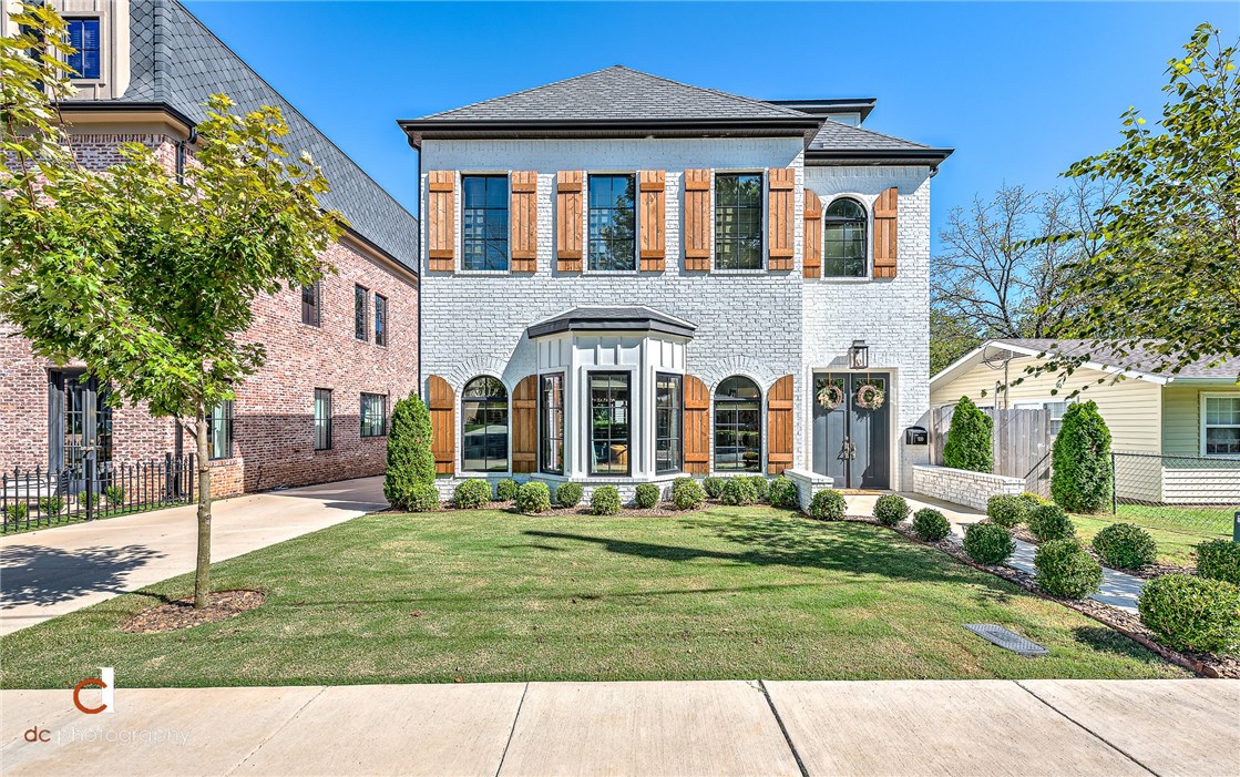 Main Street Dream Home. Immaculately detailed & designed All-Custom home built in 2017.Walking dist to Bentonville Square. The Main house is 3775 sq feet plus there is an additional 642 sq ft income producing apart/mother in law suite that is not included in the listing square footage. 4 BR, 3.5 BA, office, loaded movie room. Spacious open concept perfect for entertaining boasting prof appliances, custom cabinetry, built-ins, brick accent walls, quartz & butcher block countertops, upgraded wood clad windows, high end lighting - Restoration Hardware, floating shelves, natural gas grill hook-up, upgraded roof shingles. Charming private back porch perfect for listening to the outdoor concerts at Crystal Bridges, 2 blocks from the trails, .7 miles to ice cream at Spark cafe and a short bike ride to the 8th st. market. If you want to be a part of downtown living in a unique custom home with all the extra touches, this is the home for you.