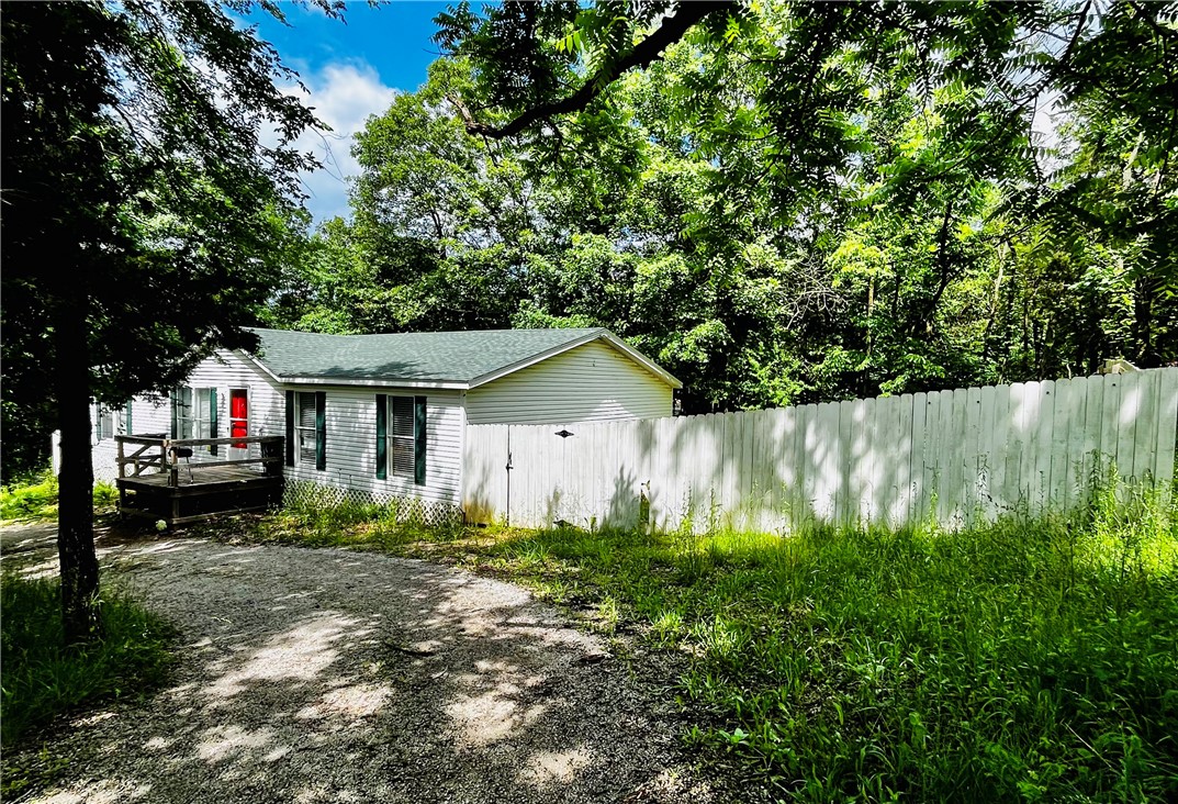 Home on a corner lot, close to Missouri state line. This 4 Bedroom, 2 Bathroom home has a fenced in backyard, circular driveway, and more room on the other side for parking. Nice big kitchen with dining room. Laundry Room with doorway going out to the deck. Home needs a little work, but with some improvements, this could be the ideal home for anyone! Home is being sold AS-IS.