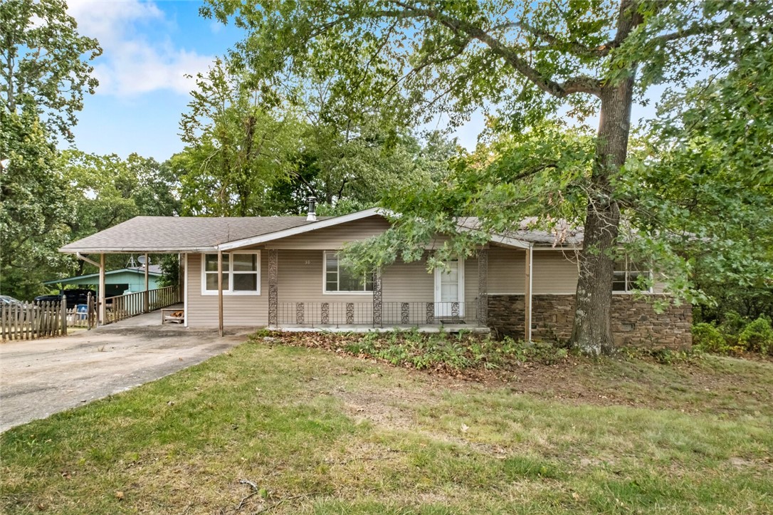 Fixer upper or investment opportunity located near Bella Vista's Back-40 mountain biking trails in a peaceful, established neighborhood with mature trees. This one-level 2 bed, 2 full bath home includes a 200 sq ft bonus room off the main living room that is NOT included in the square footage. Recent improvements include: roof replaced (2021), HVAC replaced (2018), appliances, fixtures, bathroom vanities & countertops, painted cabinets and decorative tile backsplash in the kitchen. The main living area is an open floor plan that includes a cozy wood stove, French doors leading to the bonus room, eat-in kitchen with an island, abundant cabinetry, pantry and deck access. Situated on a large lot- the side yard is fenced with a picket fence offering plenty of room for outdoor activities. Enjoy wooded views from the deck. Washer, dryer & refrigerator to convey. This is a fixer-upper/investment opportunity & will be sold AS-IS. The home is on the sewer connect list. Get your offer in by Saturday, August 23rd at 5:00pm.