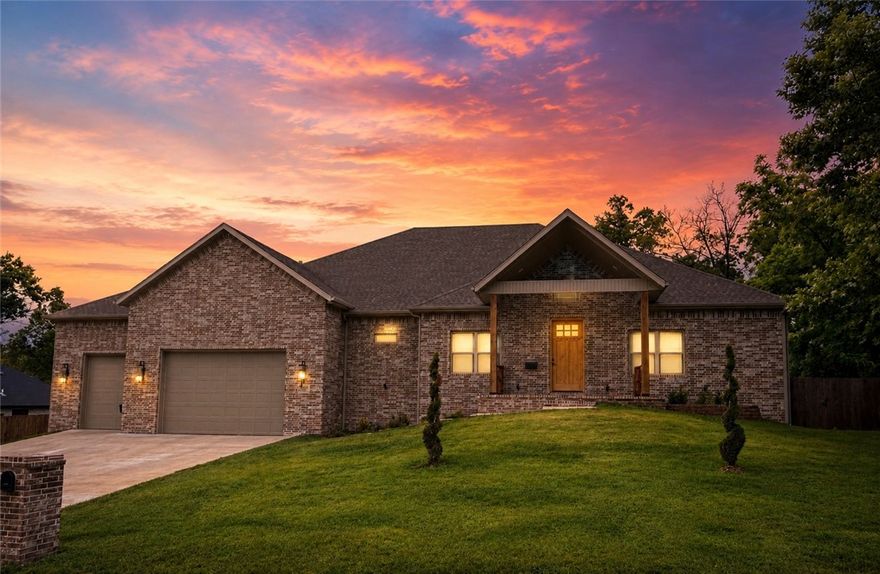 Refined living in this 2024 custom estate on 1.1 acres in Rogers. This 4-bed, 4.5-bath home features a private office and grand bonus room. The lower level offers an in-law suite with a full bath. A private movie room and versatile flex space (5th bed) provide unmatched flexibility. Premium finishes include white oak soft-close cabinetry and a JennAir fridge with matching panels. Vaulted living and dining spaces center around a 10x5 quartz island. The primary suite features a fireplace, dual rain showerheads, and a custom jacuzzi. Enjoy 700+ sq ft of covered patios and a fenced yard. The insulated 3-car garage has 10' doors and 15'4" ceilings. Fiber internet and a gas cooktop complete this luxury retreat. Seller offering $25K in closing costs, plus $5K, for $30K total with preferred lender.