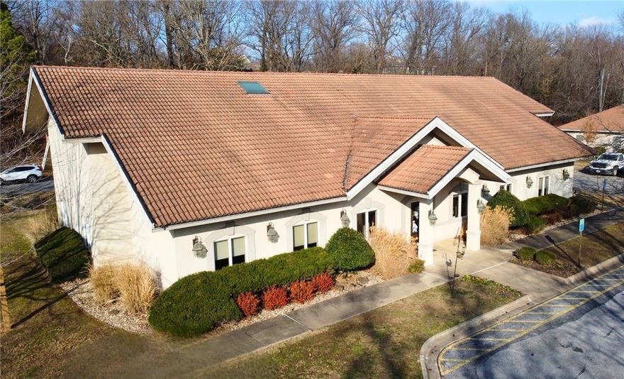 This office/medical building for sale in Rogers, Arkansas, offers ±4,764 square feet on approximately 1.06 acres within the Village on the Creeks development. The building features 10 private offices, 3 bathrooms, and 29 parking spaces, making it well-suited for medical, professional, or specialty office users. The property was intentionally constructed with superior noise control, including double-stud interior walls with sound batting, sound-treated ceilings, and baffled air vents to minimize sound transfer between rooms. Located just 0.6 miles from I-49, directly off the intersection of 52nd Street and Village Parkway, the site provides excellent accessibility and visibility in a highly desirable Rogers corridor.