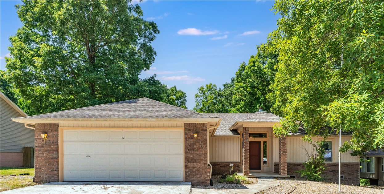 Are you looking for a quiet neighborhood close to the Back 40 trail, golf, swimming, rec center, with an easy drive to Bentonville and Rogers, to call home? This could be it! This home has 2 bedrooms and a bonus room that could be a 3rd bedroom or if you need a home office, you have it here with the 1000-gallon septic system. You will have a large living area with a cathedral ceiling that features a wooden cross beam and a gas fireplace to keep the chill off. There is 2 ways to access the treks partially covered large back deck, from the living area and primary bedroom. This private deck looks over the landscaped grass and rock backyard with an easy sloop for a nice place to play. The primary bathroom has a double sink vanity with marble countertop and a walk-in shower. The kitchen features a nice working area with some newer appliances and a pantry/laundry area that takes you to the 2-car garage. Roof replaced 2022 and deck was built 2021. Come see for yourself if this is the place to call home.