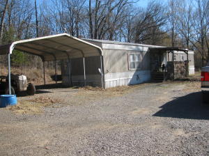 ONE OWNER....this home features 3 bdr, 2 bth, split floor plan, 16x80 mobile home, carport, fenced, barn all situated on 3.34 acres with low traffic dead end road.