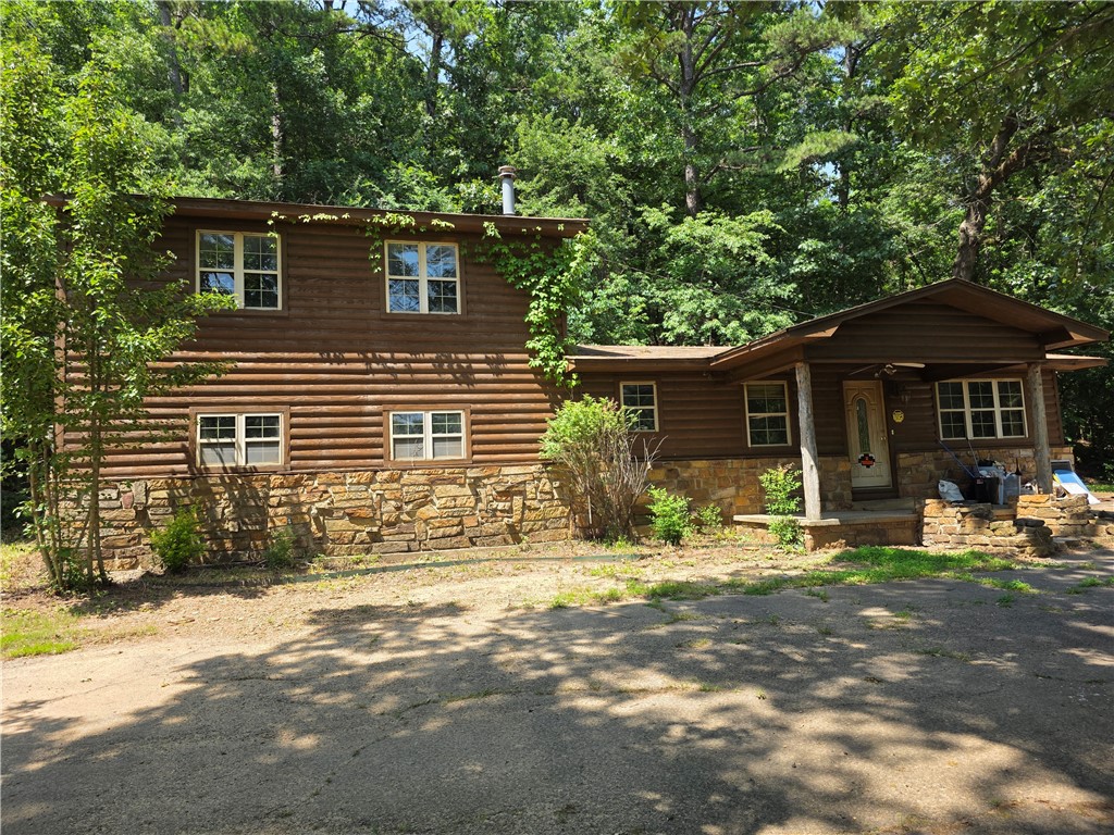 This 4 bedroom, 2 bath story and a half home near Lake Dardanelle has log siding and matching 3 car detached garage with openers on both doors. The 2.5 acres m/l setting is private, tranquil, and just minutes to town and to Lake Dardanelle, marina, and boat ramp. Kitchen/dining/ living, den, utility, 2 bedrooms and a full bath are downstairs. Upstairs there are 2 large bedrooms and a full bath.