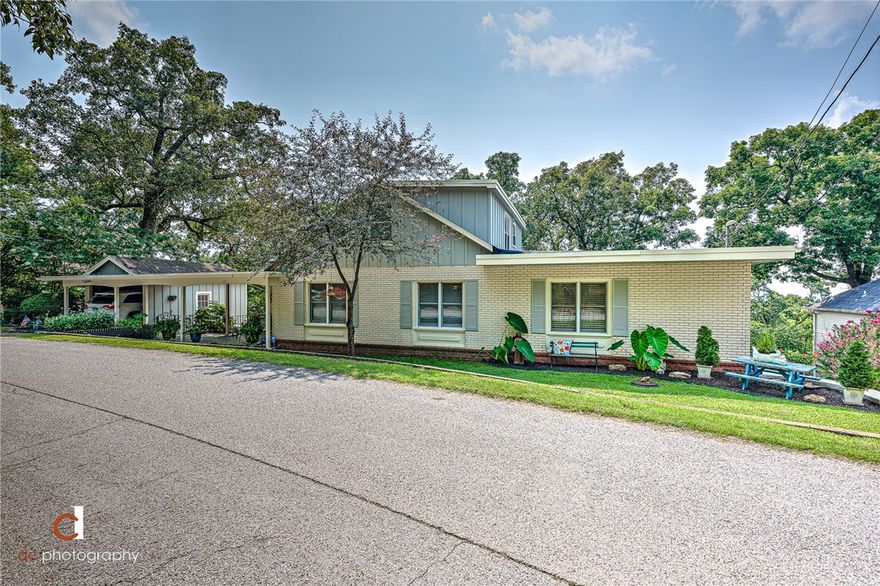 Oh the VIEW! The perfect spot to entertain and enjoy the "skyline" of Fayetteville. A must see Mt. Sequoyah home overlooking Dickson Street & facing Old Main...This family home has a ton of character & endless possibilities. Truly a Fayetteville charmer! A third level has an option for rental or income property or in-law quarters, with separate living areas, bedroom & kitchen. Built in storage is ample in this home! Many updates include a newer roof, insulation, exterior paint, bathrooms, kitchen, lighting, & an A/C upstairs. Lots extend from Skyline to Oklahoma Way. Property Sold AS-IS.