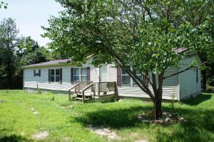 Large manufactured home located on approx. 4.21 acres. Two living areas with open kitchen, wood fireplace in den, large deck on back.