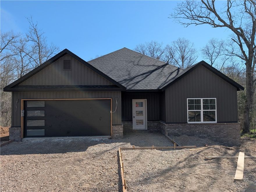 Welcome To Your Next Home At 12 Aycock Lane, Where The Yard Is Actually Usable And The Finishes Are Genuinely High-End. Tucked Away On A Quiet Cul-De-Sac, This New Construction Standout Sits On A Massive 0.45-Acre Lot Featuring The Kind Of "Bella Vista Level" Backyard That Is Nearly Impossible To Find. The Curb Appeal Is Just The Start. Step Through The Open Entry With A Custom Mudbench Into A Living Space Defined By Airy Vaulted Ceilings And Sharp Beam Treatments. The Back Wall Makes A Statement, Featuring A Floor-To-Ceiling Fireplace Framed By Windows That Bring The Wooded Scenery Indoors. The Kitchen Is Built For Real Life, Featuring Custom Cabinets, Your Choice Of Quartz Or Granite, A Vented Hood, Pantry, Under-Cabinet Lighting, And A Huge Island Ready For A Spread. Your Primary Suite Delivers With A Soaker Tub, Custom Tile Shower, Potty Closet, And Dual Vanities. Construction Wraps In April 2026, Meaning You Can Still Pick Some Of Your Own Colors And Finishes Today. Don't Just Dream About It — Come Buy It.