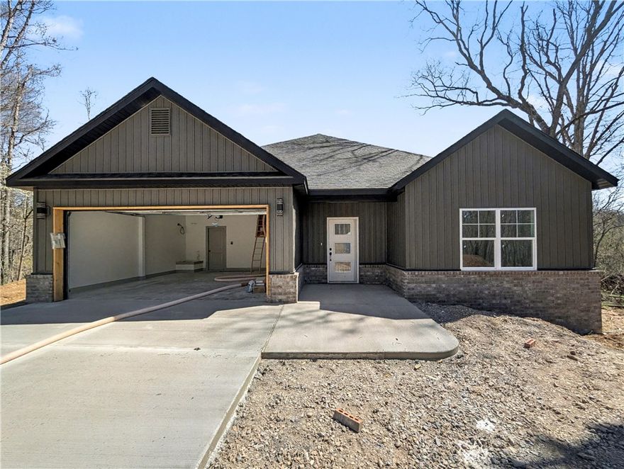 Welcome To Your Next Home At 12 Aycock Lane, Where The Yard Is Actually Usable And The Finishes Are Genuinely High-End. Tucked Away On A Quiet Cul-De-Sac, This New Construction Standout Sits On A Massive 0.45-Acre Lot Featuring The Kind Of "Bella Vista Level" Backyard That Is Nearly Impossible To Find. The Curb Appeal Is Just The Start. Step Through The Open Entry With A Custom Mudbench Into A Living Space Defined By Airy Vaulted Ceilings And Sharp Beam Treatments. The Back Wall Makes A Statement, Featuring A Floor-To-Ceiling Fireplace Framed By Windows That Bring The Wooded Scenery Indoors. The Kitchen Is Built For Real Life, Featuring Custom Cabinets, Your Choice Of Quartz Or Granite, A Vented Hood, Pantry, Under-Cabinet Lighting, And A Huge Island Ready For A Spread. Your Primary Suite Delivers With A Soaker Tub, Custom Tile Shower, Potty Closet, And Dual Vanities. Construction Wraps In April 2026, Meaning You Can Still Pick Some Of Your Own Colors And Finishes Today. Don't Just Dream About It — Come Buy It.