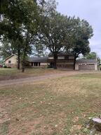 This beautiful 4 bed/3.5 bath home is just waiting for you to make it your own. Formal Living Room, Den with gas Fireplace, Formal Dining Room, 1/2 bath for guests. It boasts a large romantic master suite, with gas fireplace, tray ceilings, sitting area, large walk in closet, ensuite bathroom with two person large jetted tub & 2 person stand up shower, his & her vanities, on demand hot water heater and an electric hot water heater, Kitchen has built-in Oven, Microwave, Farmhouse sink, Upstairs is another Master bed with ensuite bath, showcasing antique claw-foot tub. Two more bedrooms and hall bathroom. There is an attached 2 car garage with a storage room/workshop area. Two car detached carport. Two septic tanks. Fenced back yard. 2 HVAC systems, one downstairs/one upstair & much more