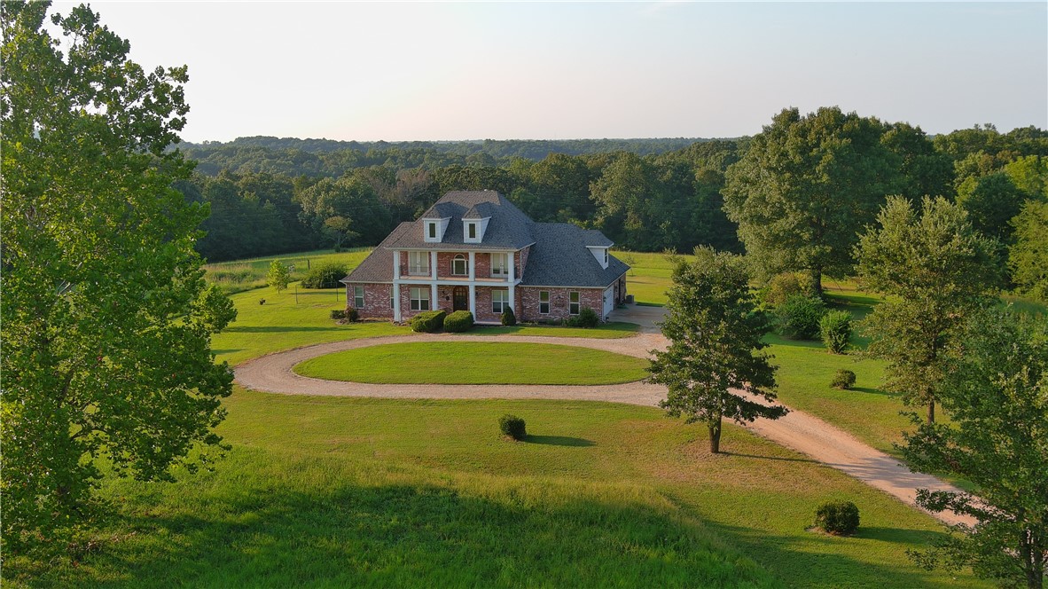 Back on the market at no fault of the sellers! The White River/Beaver Lake winds around this spacious property that includes a 4 bedroom, 3.5 bath, 3217sf home nestled on 31.86 acres mol. As you enter, you are greeted by a large foyer & formal dining room. The dine-in kitchen with granite countertops & stainless appliances opens up to a cozy hearth room with a gas fireplace. The sun-filled family room features built-in book shelves and cabinets, crown molding, & a wood burning fireplace w/insert. The main level primary bedroom features tray ceilings, large walk-in closet, his & her vanities, jetted tub, & walk-in shower. Adjacent to the primary bedroom is an office with a walk-in closet. Two staircases serve a bonus room & 3 spacious bedrooms, 2 of which open to a covered porch and a bathroom with a tub shower combo. The 4th bedroom has an en-suite bathroom with a walk-in shower. Developers take note as property could be subdivided into lake view lots.