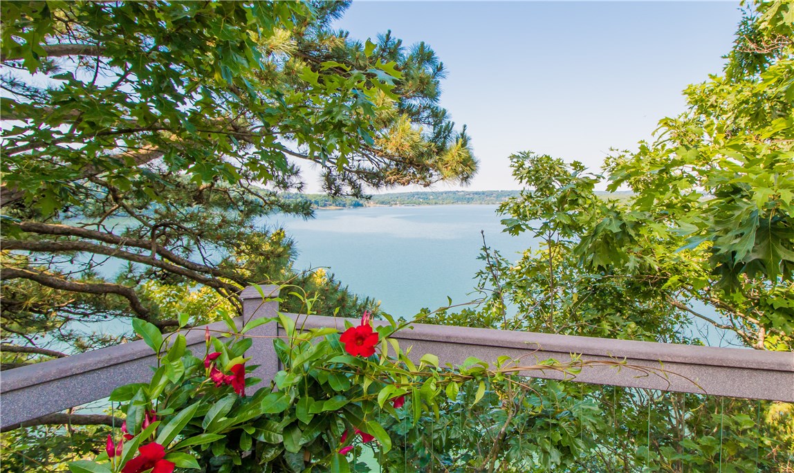 Picturesque Beaver Lake Estate gracefully poised along a breathtaking shoreline. Custom 1 owner home featuring 5 BRS, 6 baths and multiple living spaces w/panoramic views and access to alfresco living from every room. Attention to every detail w/walnut flooring, impressive cabinetry, built-ins, designer finishes, floor to ceiling windows, 7 fireplaces, walk in closets, window seating & more. Main level includes a well appointed great rm, gourmet kitchen w/copper vent hood, 2 master suites, office & spacious laundry rm. Lower level offers 3 BRS, 2.5 baths plus additional large living area. Perfect home for entertaining w/open floor plan & over 4,000 SF of expansive tiered composite decking w/hot tub & breathtaking views. Escape to the Cupola to enjoy a good book or an amazing sunset. Amenities also include 4-car garage, workshop, sprinkler system, security and abundant storage. Many recent updates: Roof, HVAC, Appliances & paint. Private co-owned boat dock included. Located just minutes from downtown Rogers!