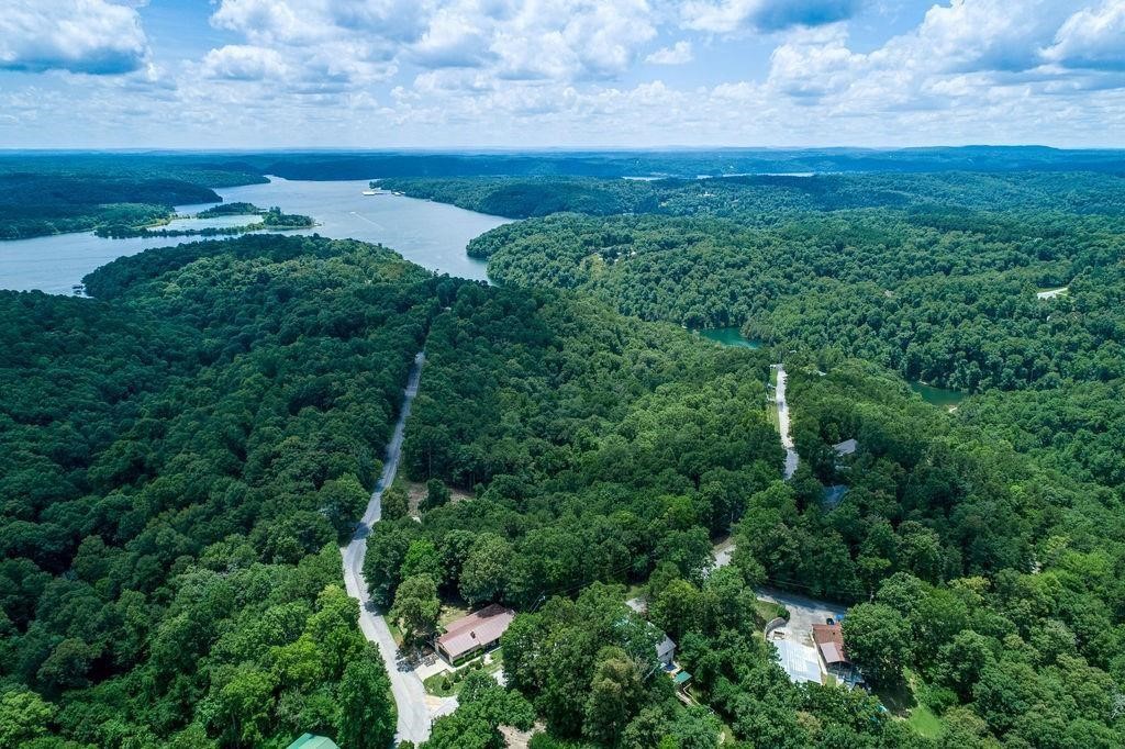 8.46 wooded acres near Beaver Lake in Beaver Shores-surrounded by nature & offering incredible privacy. This beautiful property is perfect for building your dream home, a collection of tiny homes, or even unique treehouses nestled in the woods. Enjoy close proximity to public boat launches, swimming beaches, & Prairie Creek Marina. Outdoor lovers will appreciate nearby Hobbs State Park for hiking & mountain biking, & scenic trails around Lake Atalanta in Downtown Rogers. A rare opportunity for seclusion, recreation, & convenience all in one. 8 of the acres is rural & unrestricted; the other two lots follow Beaver Shores POA guidelines and would be ideal for the entrance/exit to the 8 acres. This 8.46 acres is a peaceful, private escape with endless possibilities.