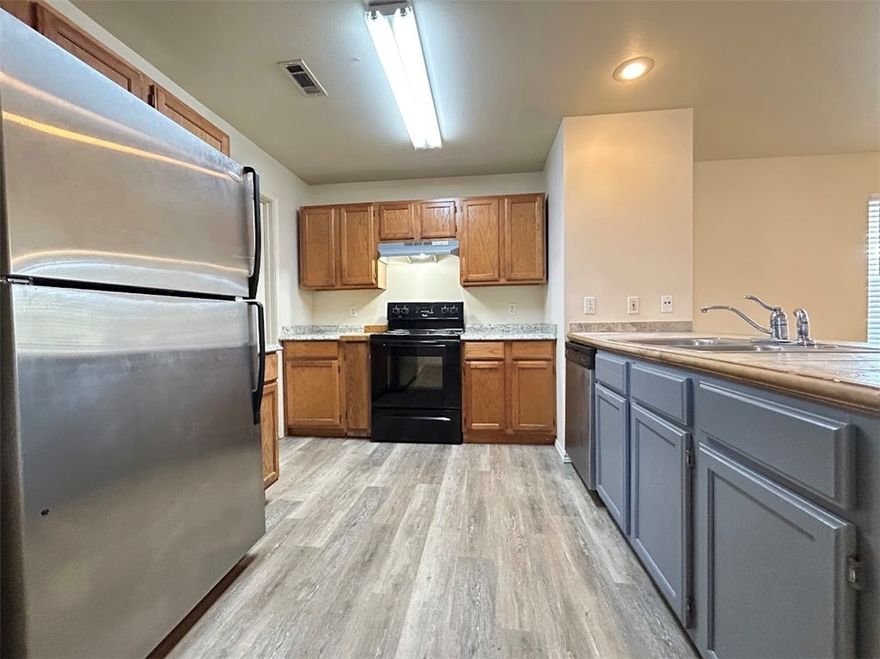 Fabulous 2 bedroom, 2 full bath apartment - 1000 square feet - Upstairs unit. Luxury vinyl plank flooring with carpet in bedrooms. All kitchen appliances include over-sized refrigerator, range, dishwasher and garbage disposal. Large open living room. Full-size washer and dryer in unit. Shower/tub combo in both bathrooms. Ceiling fans. Large front balcony. All electric unit. Tenant pays electric only. Water and trash included with rent. Great location!