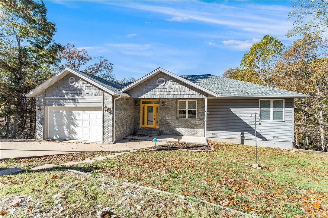 This spacious and beautifully designed 5-bedroom home offers the perfect blend of comfort, privacy, and convenience—just 20 minutes from the heart of Bentonville. With a 3-bedroom split floor plan on the main level and two additional flex rooms downstairs, there’s plenty of space for a large family, guests, or a home office setup. Open-concept main floor and walkout basement includes a large bonus room that leads to the large deck. Outside, enjoy a brand-new deck with tall wood beams and a spiral staircase overlooking a canopy of trees—ideal for entertaining or peaceful relaxation. Backing up to common space and with access to the popular Back 40 mountain biking trails, this home is a true outdoor lover’s dream. Additional features include a Generac whole-home generator and abundant storage throughout. Tucked away from the hustle and bustle, yet close to everything Northwest Arkansas has to offer, this home is a rare find! The home was built with 5 bedrooms, and the septic was installed as a 3-bedroom.