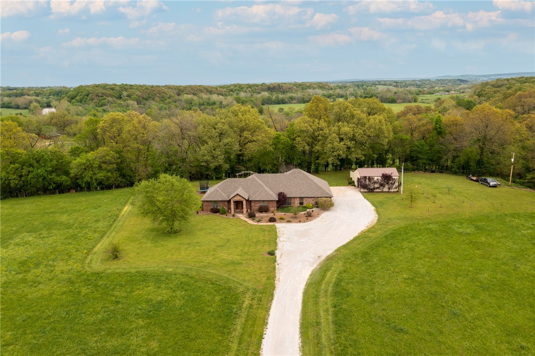 Beautiful 4 Bed 3 Bath plus office home with a seasonal river view on 8.5 acres more or less! Enjoy the gorgeous views from your covered patio or hot tub that conveys, along with a projector & speaker to watch movies. Microwave, stove, dishwasher & main hvac new in 2024,well pump new in 2017, roof & second hvac new in 2015. Home has two dining & two living areas, pellet stove in family room, gas log in formal dining, custom cabinets & built-ins galore with tons of extra storage, two 50 gallon hot water heaters, sauna & steam shower in master bath, double sinks in two bathrooms, tall ceilings, concrete & granite counters, walk-in attic storage over garage & master bedroom, fruit/fig trees, irrigation system in landscaping & much more! Has a 30x35 shop wired, decked & insulated with 100 amp service & a 3 bay shed attached. Shop also has a bathroom with shower & 400 sq. ft. in loft storage. Well water with water softener & well is 615 ft. deep. Rural water is at the road, just needs a tap. Immaculate & well cared for!