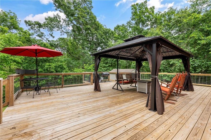 Welcome to your private escape in Bella Vista, Arkansas! Tucked away at the end of a quiet street & surrounded by mature trees, this beautifully maintained 4-bedroom, 2-bathroom home offers 2,850 square feet of serene living space on a generous 0.31-acre lot. Inside, tall ceilings & an open, airy layout create a sense of space & comfort throughout. The spacious primary suite is a true retreat, featuring a large walk-in closet, a tiled walk-in shower, & a dedicated built-in vanity room, offering both style & functionality. A versatile bonus room, already wired for a projector, adds the perfect flex space for a media room, home office, or playroom. Step outside to the expansive deck, completely redone in 2023, ideal for relaxing or entertaining while enjoying the peaceful, wooded surroundings. Enjoy all that Bella Vista has to offer with quick access to I-49, golf courses, recreation centers, scenic trails, tennis courts, workout facilities, & vibrant clubhouses all just minutes from your doorstep.