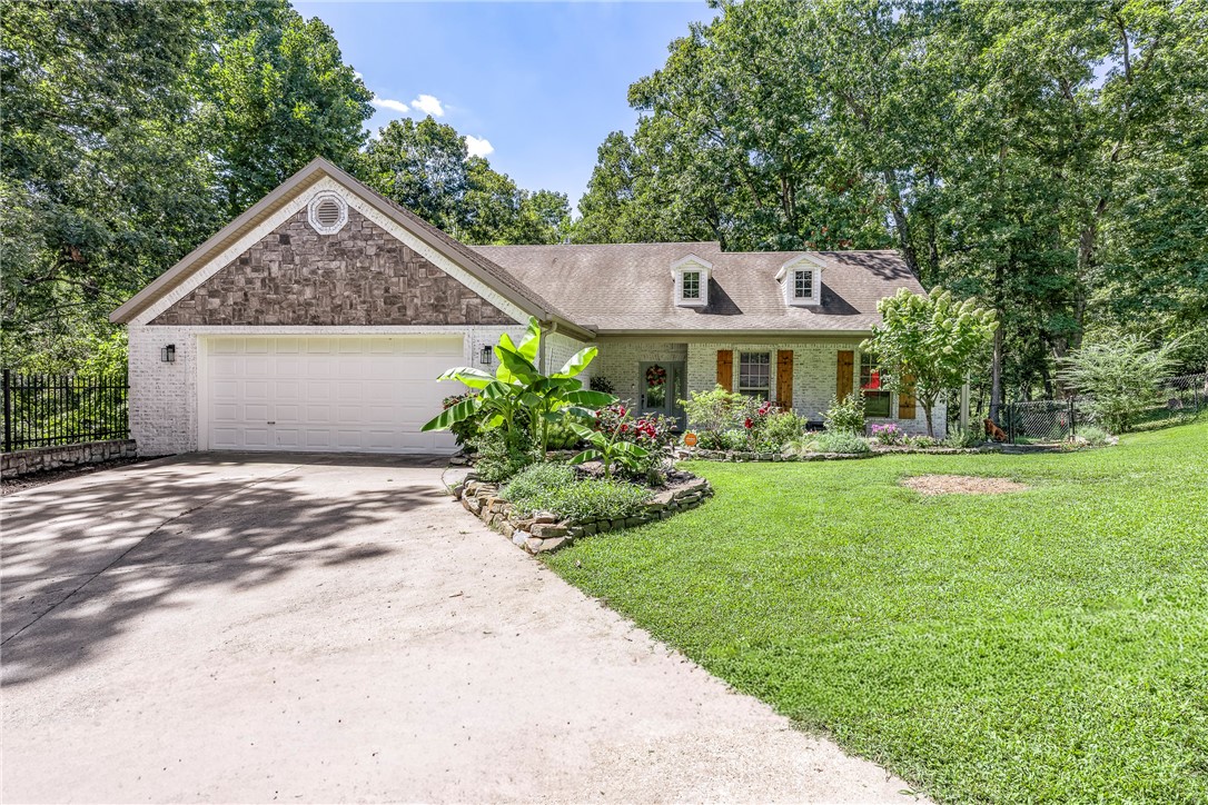Welcome to this beautifully updated home situated on a large 0.69-acre lot & surrounded by mature trees, this property offers both privacy & natural beauty. With 2,978 square feet of living space, the home features 4 bedrooms & 3.5 bathrooms, including a primary suite on each floor. Each level also offers its own kitchen, living room, & laundry area, making the layout ideal for guests, or flexible use of space. Stylish updates are found throughout, & recent improvements include a new upstairs HVAC system installed in 2023. A fully encapsulated crawl space w/ triple sump pump, dehumidifier, & French drain added in 2022, all backed by a 25-year warranty. Two covered back decks provide the perfect setting to enjoy the peaceful wooded backdrop, abundant wildlife, & three-season outdoor living. Additional features include RV parking & a prime location just minutes from downtown Rogers, Lake Atalanta, & Beaver Lake, offering the perfect blend of privacy & convenience.