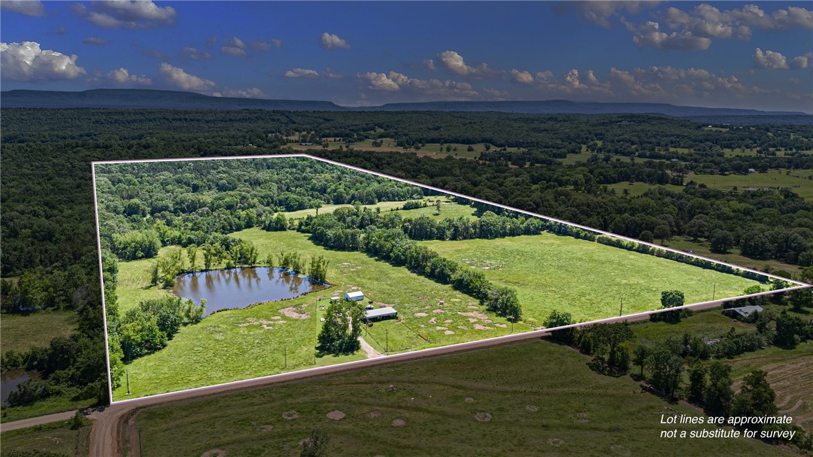 Seize this rare opportunity to own 80 high-potential acres—a full ¼ section—designed for efficient, profitable operations. This well-balanced tract features approximately70% productive pasture and 30% timber, offering both grazing and recreational value. Property is fully fenced and cross-fenced for optimized rotational grazing. There are two stocked ponds ensuring reliable water sources for livestock and potential recreational use. There is also a covered holding pen adding operational flexibility.
The 24x30 metal building has a built in "tiny home"; 11x24 functional living quarters (including an open living/sleeping space and a combined bath/laundry room). The only thing needed is a septic system.
The rich, previously cultivated soil (once used for soybeans) provides excellent potential for crop diversification or increased hay production. Currently supports 22 head of cattle and yields an average of 60 round bales of hay annually providing steady, recurring revenue.