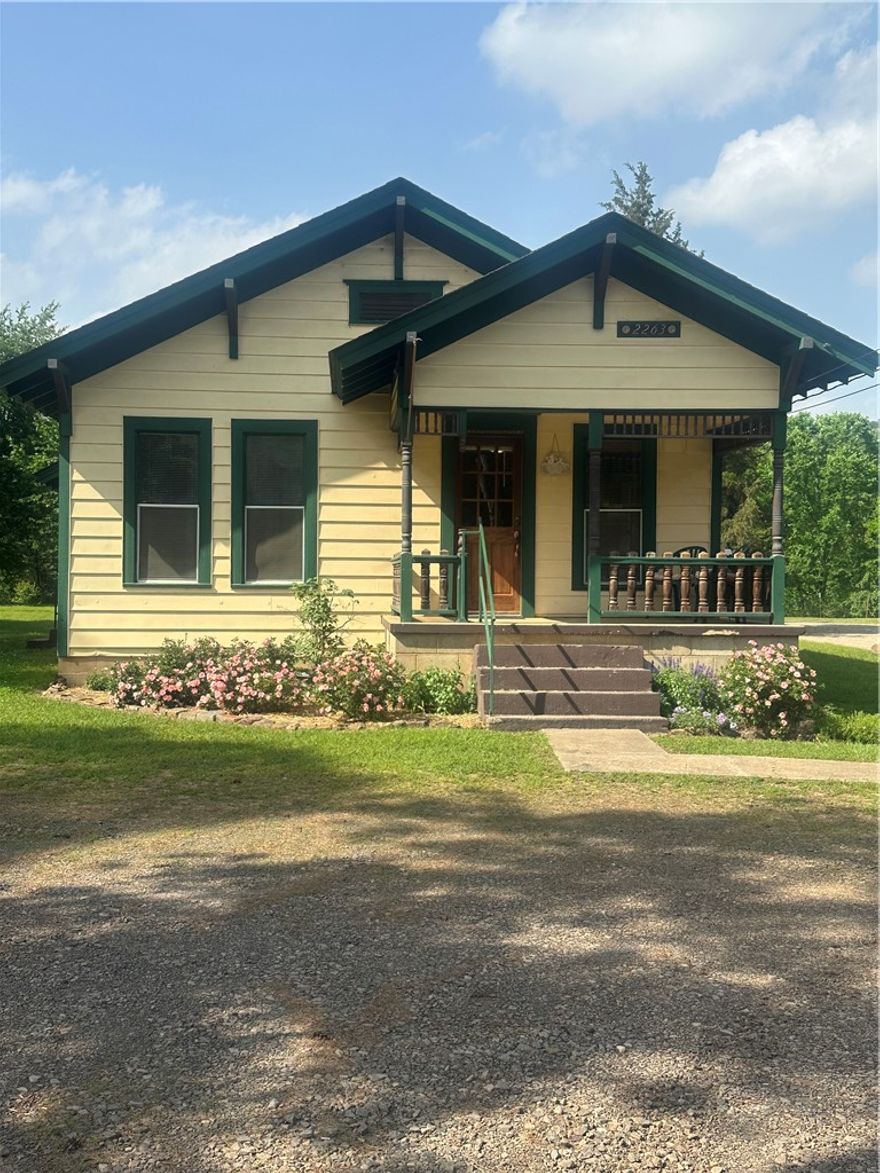Charming Country Home with Shop on Highway 103! This charming 2BR/1BA home sits just outside Clarksville city limits on Hwy 103N. Beautifully landscaped and well-maintained property blends comfort, charm and practicality!! It offers peaceful country living with convenient access to town.  There is detached 18x30 (approximately) garage/shop with concrete floor, roll-up door, and two man doors ideal for storage, a workshop, or hobby space.