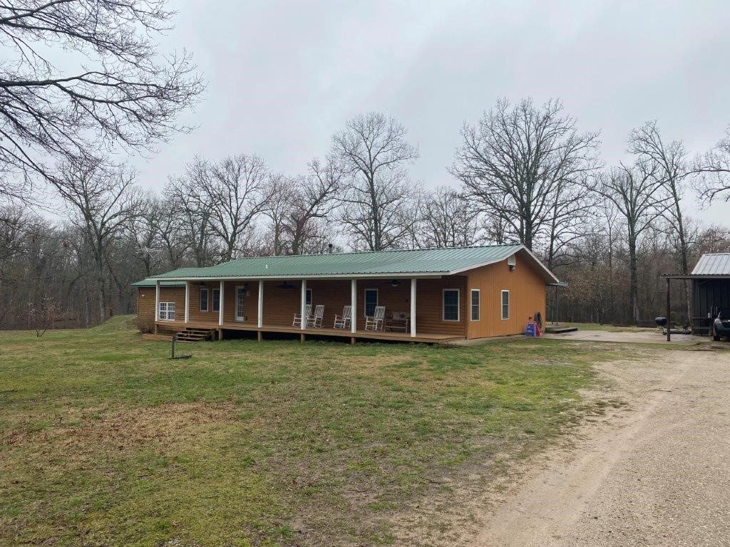 RARE FIND- Mini Farm 2344 SF house 465 SF guest house, total of 4,047 SF of shop area consisting of 3 buildings. The 6.5 acres m/l is level cleared with mature trees located at the end of the road and at the back side of JAC’s Ranch between Bentonville & Pea Ridge. Pea Ridge schools. Two parcels, 1 septic system. 2 30x40 shops have concrete floor insulated with electric & a wood stove. 3rd shop 37x31 (Tractor barn) has dirt floor. 20X25 covered carport area is attached to one of the shops.