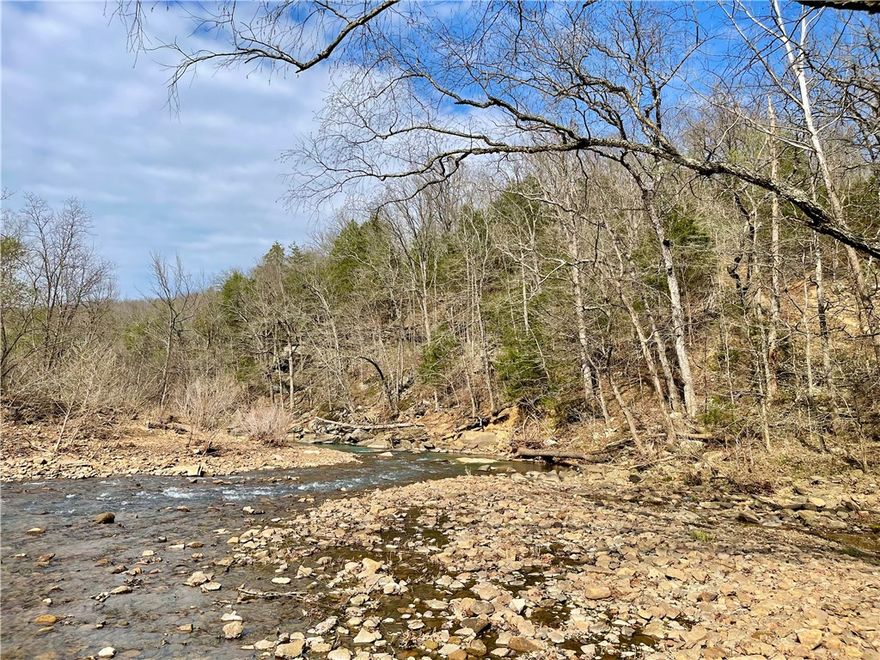 70 acres in the Ozarks within a 30 min drive to Fayetteville, AR. Escape to your own private oasis with this stunning recreational property, featuring scenic building spots, an off-grid cabin, and the tranquil flow of Lollars Creek right below the bluff line. Whether you're hunting, hiking, riding, or fishing for smallmouth in the deep swimming holes, this property truly offers it all. All hwy frontage to the entrance.