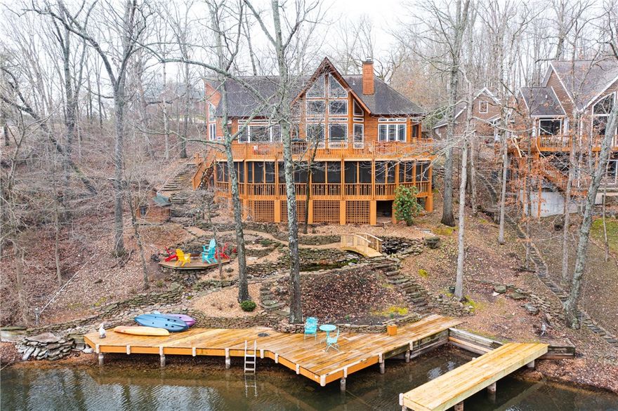 Don't miss a chance to see this beautiful lake house located on Loch Lomond. This house is amazing in every way and the outdoor space is second to none. The quiet cove, private boat dock, and fire pit make for an amazing place to lounge and swim. The open floor plan with tall ceilings makes for the perfect place to host friends and family. The house was originally built by a landscape architect, and it is beautiful in the spring and summer.