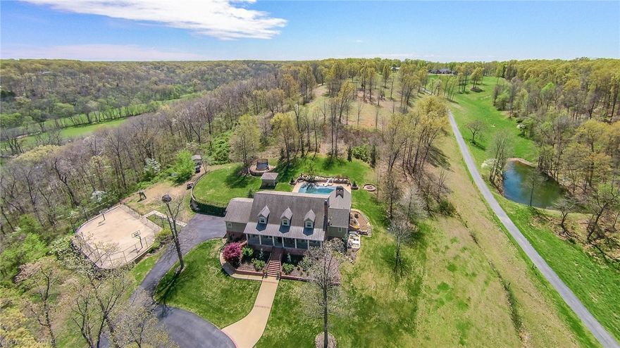 Stunning Hilltop Bentonville Estate with Million dollar views on 6 acres!  Private park-like setting with saltwater pool, full-court basketball court, outdoor fireplace and large outdoor entertaining spaces!  Gorgeous interior decorating details throughout, quality design and great interior layout featuring over 6500 sfeet, 5 Brs, 5.5 Baths.    Beautiful Gourmet Kitchen, Luxurious master bedroom and bath suite, office, formal and casual living and dining spaces.   Basement area with large media room, kitchenette, exercise room and tons of storage, 6 car garage.