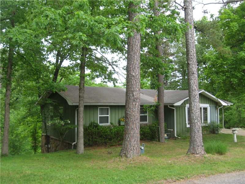 Great quiet neighborhood, quaint cottage with finished walk out basement, covered 1 car carport w/ storage, work shop in basement, 1 bedroom and full bath in finished basement along with setting room w/ wood burning stove, bonus room with small bar,freezer & 2nd refrigerator, lower covered patio. Main level has 3 bedrooms and full bath, living room, eat in kitchen, covered screen-in porch, refrigerator, 2188 square feet, (New Roof 5-15-15) lots of extras.