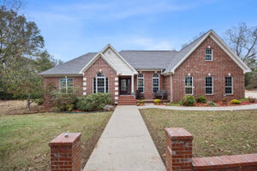 Discover your own private retreat on this stunning 5.54-acre property, perfect for both relaxation and entertaining. Enjoy the spacious outdoors, shaded by mature trees, with a beautiful in-ground pool that invites you to unwind. This all-brick, 4-bedroom, 2.5-bathroom home offers elegance and comfort, with tall ceilings, crown molding, and luxurious granite surfaces throughout. Inside, you'll find a dedicated office space, ideal for working from home or managing projects.