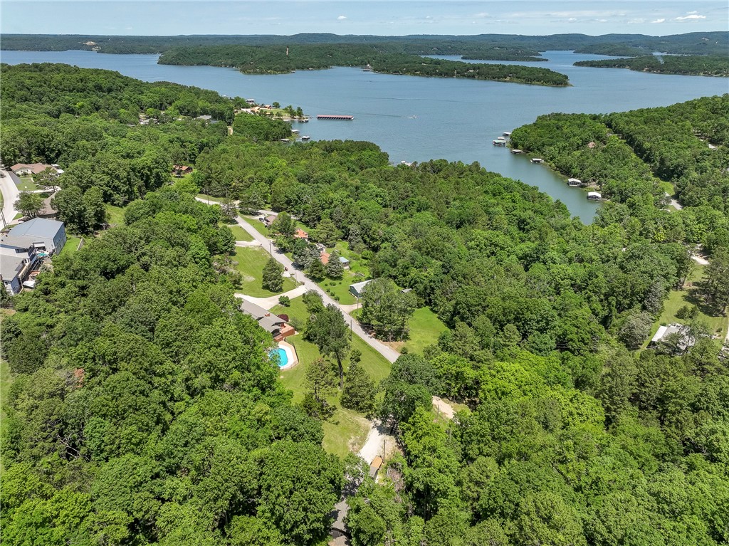 Back on the market at no fault to the seller & Seller Financing is Available! Escape to your own peaceful retreat near Beaver Lake! This charming home sits on a scenic 1.07-acre lot just 0.7 miles from the community boat launch & minutes from Rocky Branch Marina, Hobbs State Park, & Shaddox Hollow Trailhead. Perfect for outdoor lovers & investors alikeāideal as a short-term rental, long-term rental, guest house, creative studio, or private getaway. Recent updates include new 30-year impact-resistant fiberglass shingles, fresh interior/exterior paint, & new flooring. A 12x30 pole barn & 8x10 storage shed offer room for lake toys, tools, or hobby space. The wooded setting offers privacy, while the location keeps you close to adventure. Whether you're building passive income or looking for a quiet weekend escape, this property has potential to match your vision. Donāt miss this affordable opportunity to own near one of NWAās most beloved destinations!