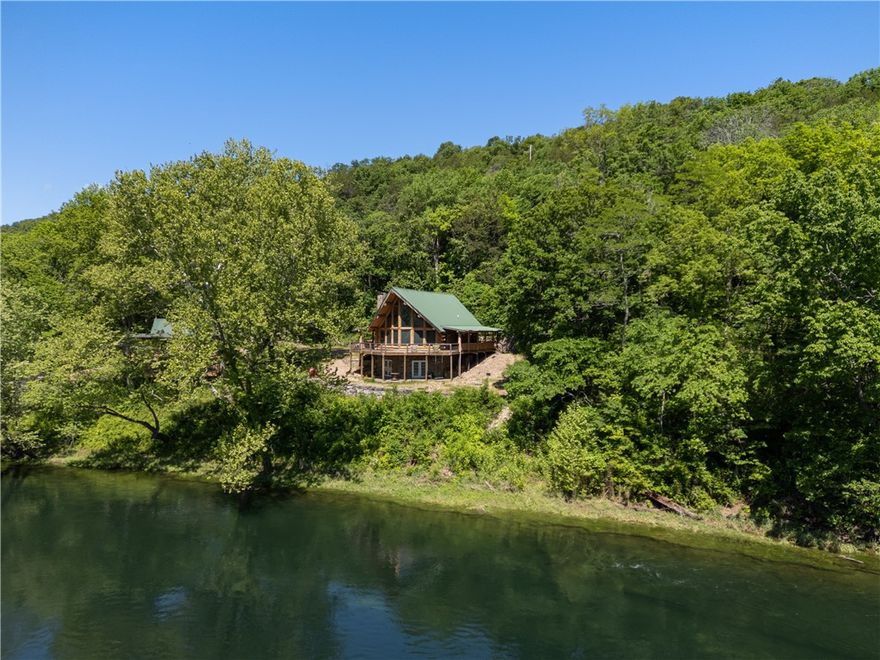 White River Waterfront Retreat!  Situated on the banks of the White River below the Beaver Lake Dam, this 46-acre retreat offers privacy and solitude. Home to the Tailwater Club, it features a 2500 sq ft lodge with stunning views, easy water access, and only the sounds of nature.  The 5bd/3ba Log Cabin Lodge boasts spacious rooms, a walkout basement, and a deck with downriver views. Accessible by county road or the adjacent state park, it's 30 minutes from Downtown Rogers, 20 minutes from Eureka Springs, 10 minutes from Mtn Bike Trails, and 5 minutes from Beaver Lake. Private guided tours are available by appointment. Please also see the 42+/- Land MLS# 1296438