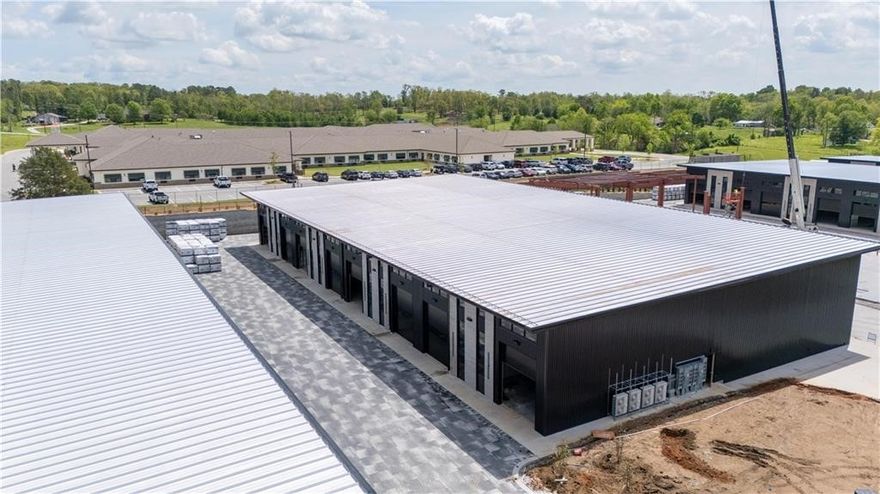 The Marque Collection Suites are taking shape in the heart of Rogers, Arkansas. Designed for discerning collectors and enthusiasts, this premier development offers a unique opportunity to own prime real estate in a purpose-built, upscale community. Your space away from home- a pad for collectors or just a gathering space. No matter what your hobbies are, Marque Collection Suites is built to host it. Conveniently located adjacent to the Promenade Mall in the thriving Entertainment District. 1.5 Miles from Pinnacle country club, Estates at Southgate, and Shadow Valley. Secure your spot today and be part of Northwest Arkansas' first collector-focused community. Don't miss your invitation to be a part of this prestigious opportunity. Come join like-minded enthusiasts in a purpose built gated community. Units have 14'H X 12'W overhead doors. Mezzanine can be added by buyer from Preferred contractor or accepted contractor.