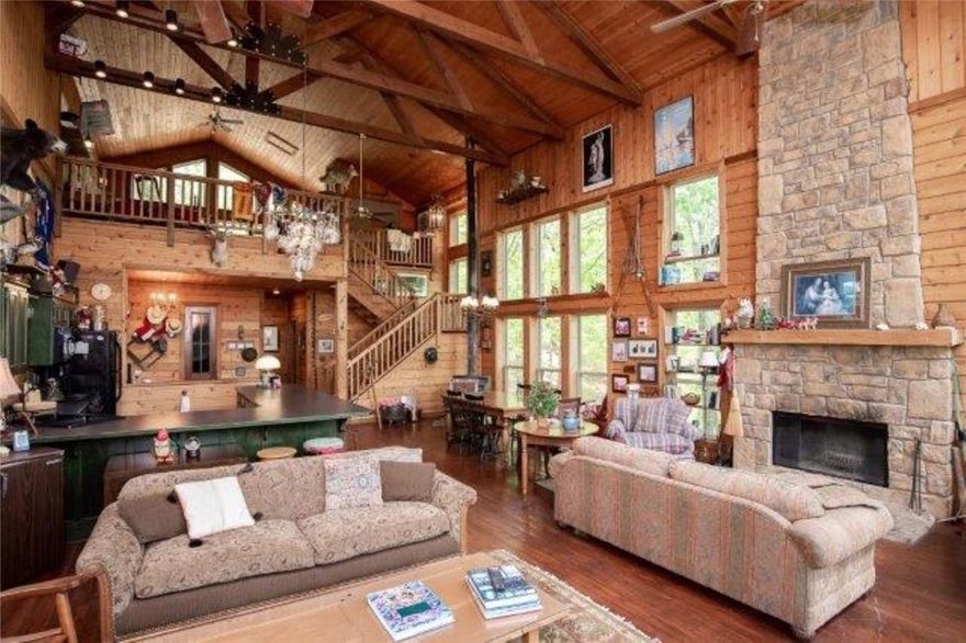 One of a Kind “Cabin” filled w/character. Lovingly custom built, refinished old doors & fixtures, main level: stained wood floors, 3 levels of windows w/wooded views enhance the open living, dining, & kitchen w/L-shaped bar, master. bdr. & bath w/whirlpool, woodburning FP; basement:10-foot ceilings, finished w/barn siding & stained concrete floor, two bedrooms, FP, bath, wine cellar, laundry room & extra storage. Large loft w/bath & closet. All this wrapped by a L-shaped deck, perfect for entertaining or spending time under the stars. 31 acres of privacy, 1000 ft. of lake frontage in Devils Gap cove.
No zoning for a boat dock, located close to a public launch on Buttermilk Rd. Selling furnished. Truly Special!