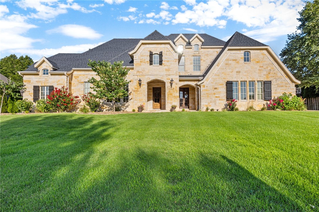 Welcome to Thornbury, north Springdale’s most esteemed address! From its beautifully landscaped cobblestone entrance, through the quaint covered bridge, and just past the private neighborhood trail connecting to the Greenway, you’ll find this stately limestone estate-style home on a half-acre. Teeming with rich wood accents, this custom stunner features five bedrooms and extras like the butler’s pantry, ice machine, hand-scraped flooring on the main level, brand new carpeting, a warmly paneled office and large upstairs bonus. Outside, shoot hoops, enjoy a refreshing summer dip in the heated diving pool, or kick back on the covered patio with a cozy outdoor fireplace. This incredible extended living space is an entertainer’s dream, boasting an outdoor kitchen with wonderful bar seating and an entrance into a full bath just inside. New roof in 2021. Don’t miss a chance for your private showing now— with plenty of summer and fall to soak up all the pleasures of this gorgeous retreat!