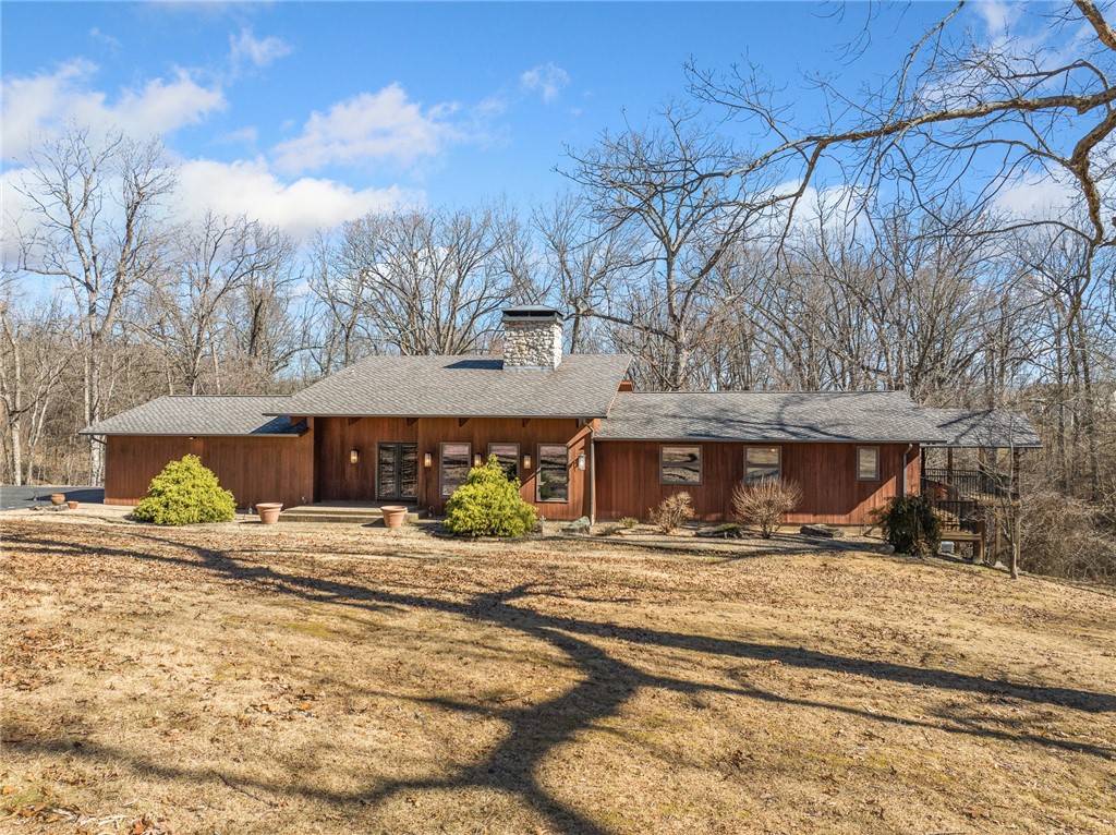Experience the beauty of this unique 39.5-acre property, nestled between the best water features of Arkansas and Missouri. Enjoy wildlife sightings, including deer and turkey, from the stunning 4,000 +/- sq ft custom redwood home. Perfect as a private family retreat or a second home, yet only minutes from town. A paved driveway leads to the 3-bedroom, custom home featuring a striking 30 ft limestone fireplace in an open floor plan spanning both upper and lower levels. The master suite includes a spacious living area that can easily be converted back into another bedroom. The designer kitchen is a true standout, with custom-built cabinetry, exposed beams, and top-tier Sub-Zero and Wolf appliances. For additional storage, a 25 x 40 custom redwood barn with electricity is also included. This exceptional property offers privacy, luxury, and convenienceāan ideal setting for those seeking peace and accessibility in one remarkable package.