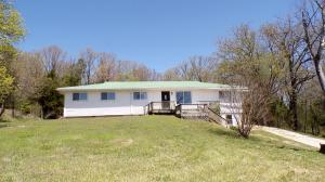 Country home on paved highway. Spacious 3 bedroom 2 bath home. Wood burning fireplace, CH&A, pine floors. Close to Bull Shoals Lake. Sell As-Is.