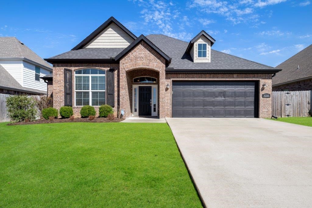 Great location in established neighborhood in SW Bentonville. Main level features a split 3 bed and 2 full bath with open floor plan. Spacious Primary bdrm is accented w/vaulted wood beam ceiling, two vanities split between whirlpool tub, walk-in tiled shower, private water closet & walk-in closet. Both secondary bedrooms have walk-in closets. Full bath in hallway services both bedrooms & guest. You will love entertaining & gathering around the huge island in the kitchen! White cabinets, 3cm granite countertops, gas stove, white cabinets, ample cabinet/storage, kitchen window above sink, panty, open to dining area with vaulted ceilings. Floor to ceiling stone accented gas FP w/stained wood mantel. Upstairs is a huge bonus rm or 4th bdrm. Other features incl built in cubby area, wood floors, crown molding & extra storage. Exterior has great curb appeal, covered patio & wood privacy fenced back yard. Cornerstone Sub has a community pool, walking trails and playground. Convenient to all that Bentonville has to offer.