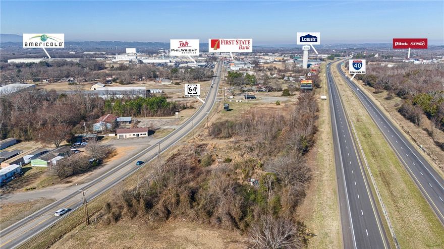 455 Ft of INTERSTATE 40 Visibility. Over 2 level acres will give you maximum exposure with I 40 and Hwy 64 frontage. Prime location for a business seeking easy Hwy 64 access. Close proximity to local amenities and major roadways. 447 ft of Hwy 64 frontage. ARDOT 2021 Hwy 64 traffic count 8300 daily. Access to city water is directly across Hwy 64.