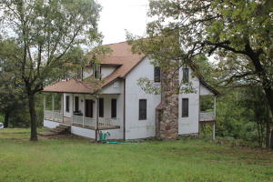 Custom built home on 26.6 ac M/L joining Crooked Creek. This home features master suite on main level with large walk in closet. Kitchen with breakfast nook and formal dining room just off the grand living room. Covered decks to take in the views and three bedrooms with bathroom on upper level. Full walk out basement has family room with stone fireplace, craft room or just use as storage area, two car garage and utility room with full bath. Large 30x40 workshop and lots of room for a garden or a few horses.