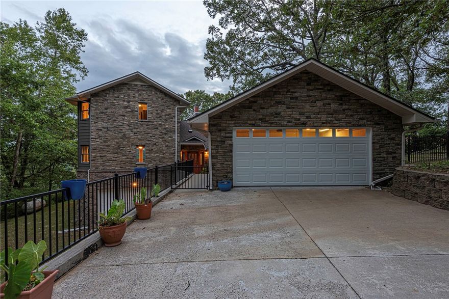 SPACE & SERENITY! Perched above the waters of Beaver Lake, this 5 bd, 3 full bath, 2 half bath home sits on 6.88 ac w/ views you can’t miss! Inside, a foyer connects the heart of the home: kitchen, dining, living, & outdoor spaces—ideal for entertaining. Main lvl feat: split floor plan w/ large living rm w/ wood floors, panoramic lake views, large kitchen, & main flr primary w/ ensuite & tiled shower. Three add’l bedrms, 1.5 baths, & large laundry w/ storage & utility sink! Upstairs, your own private retreat: 2nd primary w/ views, upper deck access, walk-in closets, & spa-like ensuite w/ soaking tub, sauna, & shower. Lower lvl access to 2-car garage & workshop space w/ half bath! Outside, relax & rejuvenate w/ iron-fenced backyard, cliffside gazebo, rock garden, detached 2-car garage, & 1,516 SqFt insulated metal shop w/ electricity—perfect for your boat. 5 mins to Blue Springs boat access! This one-of-a-kind home offers a front-row seat to The Natural State's beauty. Don't miss out—your lakefront lifestyle awaits!