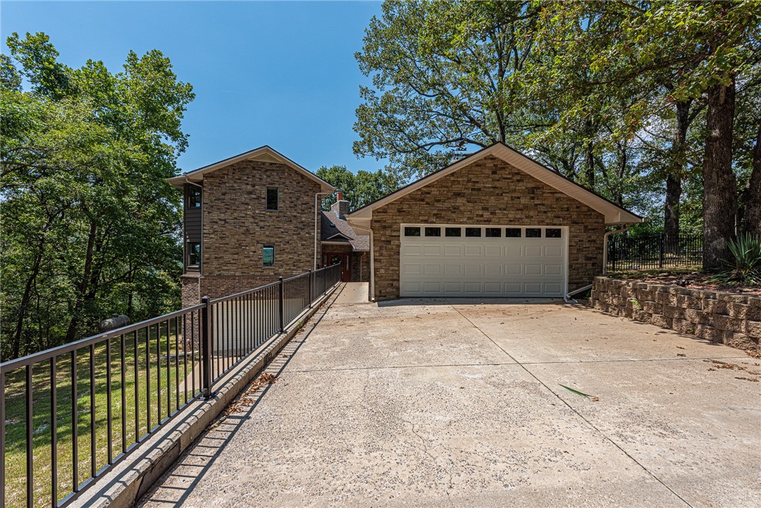 SPACE & SERENITY! Perched above the waters of Beaver Lake, this 5 bd, 3 full bath, 2 half bath home sits on 6.88 ac w/ views you can’t miss! Inside, a foyer connects the heart of the home: kitchen, dining, living, & outdoor spaces—ideal for entertaining. Main lvl feat: split floor plan w/ large living rm w/ wood floors, panoramic lake views, large kitchen, & main flr primary w/ ensuite & tiled shower. Three add’l bedrms, 1.5 baths, & large laundry w/ storage & utility sink! Upstairs, your own private retreat: 2nd primary w/ views, upper deck access, walk-in closets, & spa-like ensuite w/ soaking tub, sauna, & shower. Lower lvl access to 2-car garage & workshop space w/ half bath! Outside, relax & rejuvenate w/ iron-fenced backyard, cliffside gazebo, rock garden, detached 2-car garage, & 1,516 SqFt insulated metal shop w/ electricity—perfect for your boat. 5 mins to Blue Springs boat access! This one-of-a-kind home offers a front-row seat to The Natural State's beauty. Don't miss out—your lakefront lifestyle awaits!