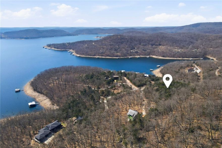 Discover the natural beauty of Beaver Lake with this lake view (clearing needed) vacant parcel off Sunrise Cove in Garfield. Featuring dramatic rock bluffs and a proposed building site, this property offers the perfect canvas for your future home or getaway retreat. Situated minutes from Indian Creek Park and Dam Site Park, you won't have to go far for recreational opportunities! Enjoy the privacy and character of the Ozarks while still being conveniently located...just 30 minutes to Rogers and 30 minutes to vibrant Eureka Springs. Gateway Water at the road. Septic needed. Design and build exactly to your vision on a unique piece of lake area land. (Please do not go beyond chained road without permission or an agent.)