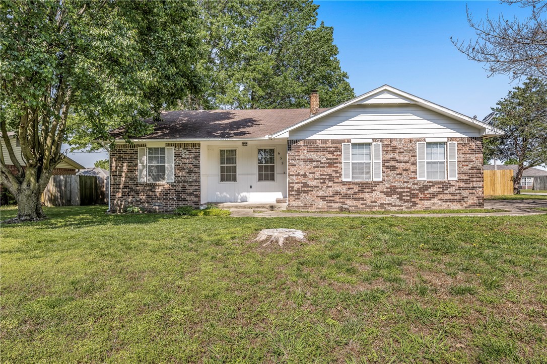 A Gentry charmer! Welcome to this beautifully updated 3-bedroom, 2-bathroom home located in a quiet neighborhood in Gentry, AR. Nestled on a spacious .36-acre corner lot, this property offers the perfect blend of comfort, privacy, and outdoor space. Step inside to find a wood burning stove in the living area, an updated kitchen, and a cozy sunroom — perfect for enjoying your morning coffee or relaxing with a good book year-round. The primary suite includes a private bath and ample closet space, while two additional bedrooms offer flexibility for guests, a home office, or growing families. The garage has a large workshop, perfect for hobbies or crafts. Outside, enjoy entertaining under the covered patio, and the large new wood privacy fenced-in backyard, ideal for pets or kids. This home combines small-town charm with easy access to local amenities, schools, and parks. New flooring, paint, and fixtures throughout! Kitchen refrigerator and laundry washer and dryer convey! This one is move-in ready! Welcome home!