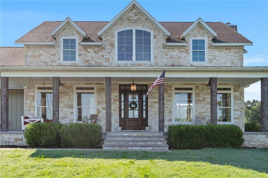 Welcome to your dream home! Nestled on 16.23 acres, this property blends luxury, comfort, & space. The large patio warmly greets you, setting the tone for this exceptional home. The chef's kitchen features a double oven, gas cooktop, & pantry. Adjacent are multiple living areas, including a sitting room/formal dining & second living area, ideal for entertaining or relaxing. Two offices provide ample space for remote work or study. With 5 generous bedrooms & 4 bathrooms, this home accommodates families of all sizes. The primary bedroom on the main floor has direct access to an outdoor sitting area. A fun fireman pole offers a quick way to the main level. Large windows flood the space with natural light. Cozy up by the wood-burning fireplace on chilly evenings. The covered patio out back is perfect for outdoor dining and entertaining, with a bathroom featuring outdoor access. Enjoy country living with a shop, hay barn, corral, & fencing established for farm animals, while being centrally located to all NWA offers.